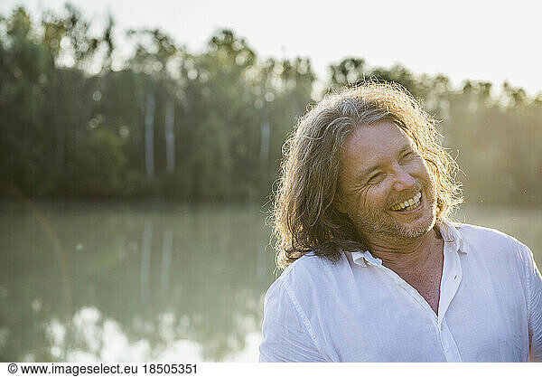 Cheerful man laughing by river  Bavaria  Germany