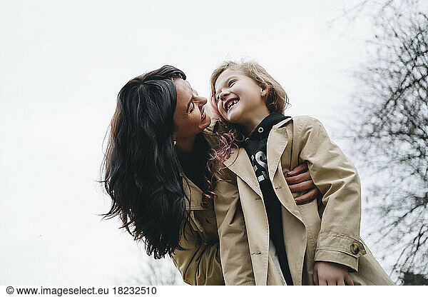 Cheerful mother and daughter enjoying in park