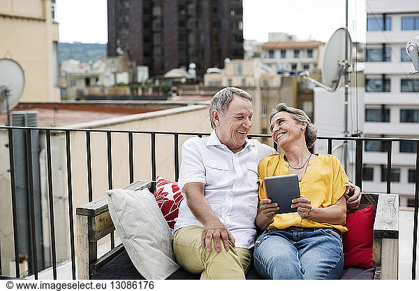 Cheerful senior couple spending leisure time on terrace