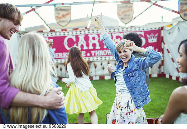 Cheerful woman celebrating victory in game in amusement park