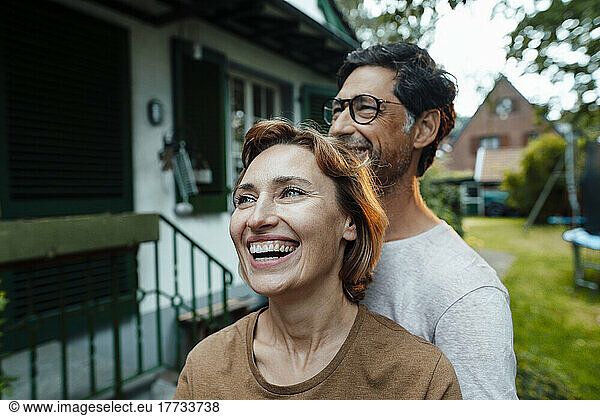 Cheerful woman with man in back yard