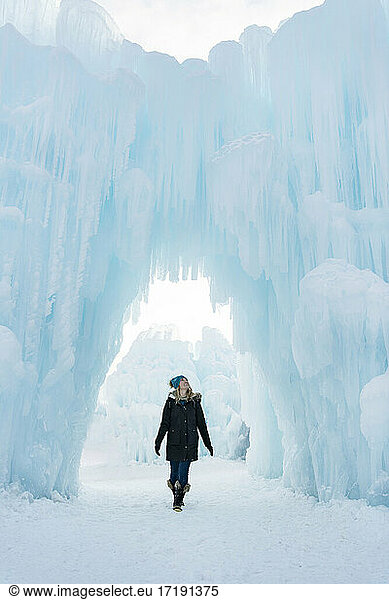 Cheerful young woman walking in Ice Castles