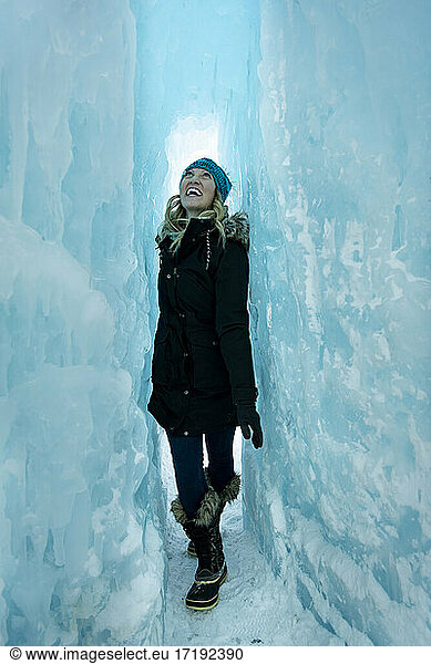 Cheerful young woman walking in Ice Castles