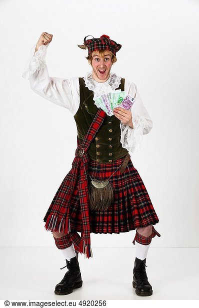 cheering scotsman holding a bunch of euro banknotes