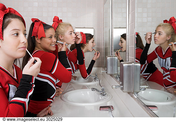 Cheerleaders putting on make up