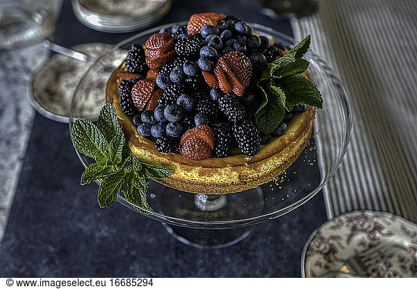Cheesecake and berries with mint leaves