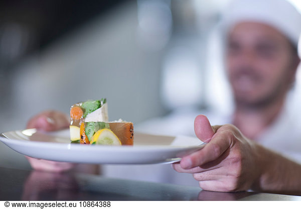 Chef placing meal on counter for service