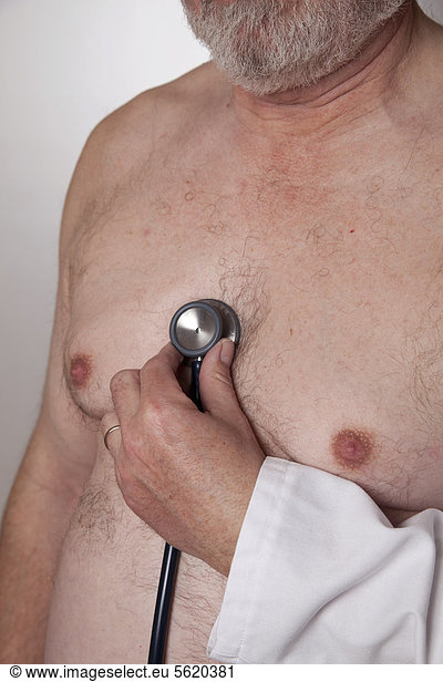 Chest of an elderly man  doctor listening to heartbeats with a stethoscope