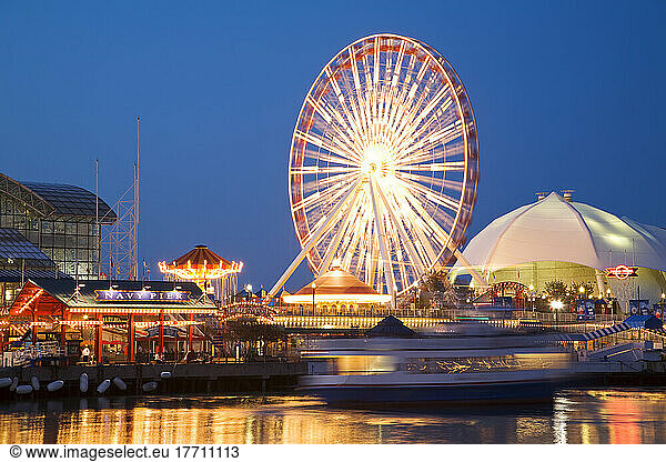Chicago  Illinois Boat Pull Away From Dock At Navy Pier At Night  Ferris Wheel And Skyline Stage