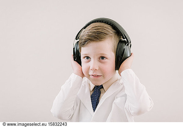 child in labcoat with headphones