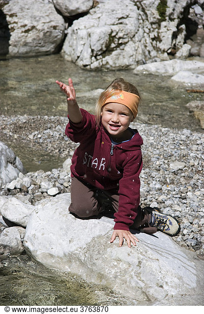 Child playing in stream