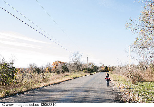 Child running on country road