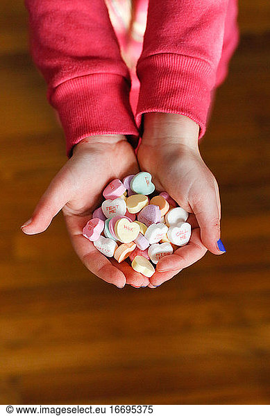 Child's Hands holding candy hearts on Valentine's Day