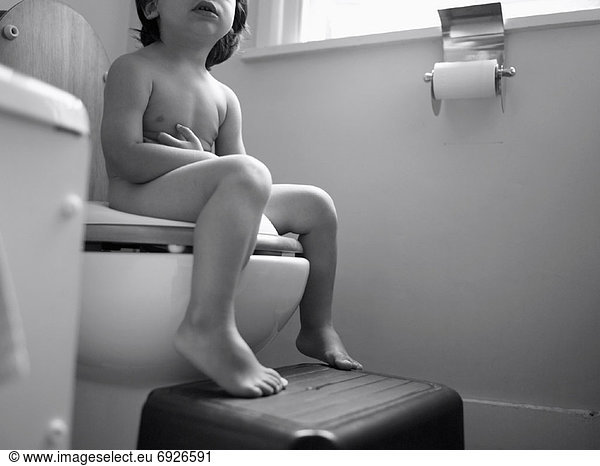 Child Sitting on Toilet
