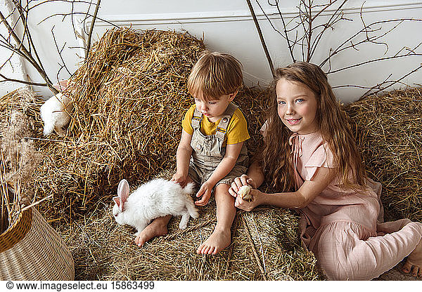 Children at Easter with rabbits and ducks