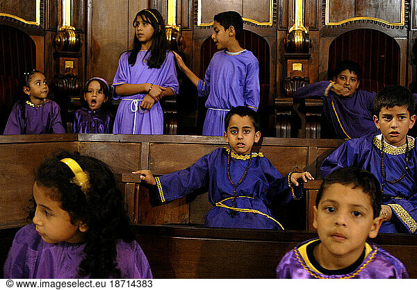 Children attend holy week mass dressed in traditional purple robes in Merida  Venezuela.