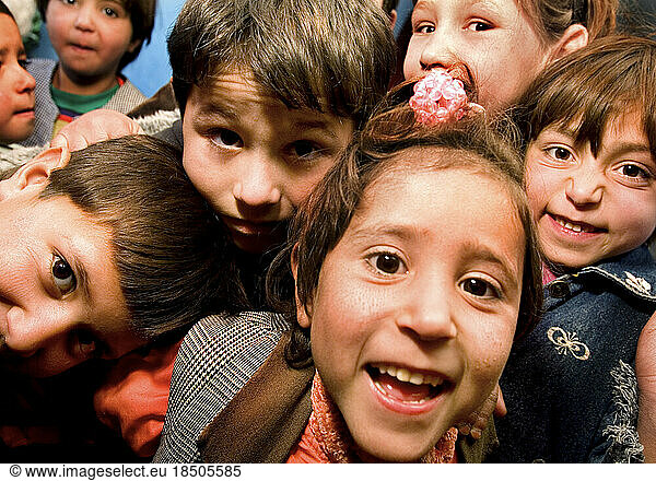Children crowd around the camera at a Kabul child care center.