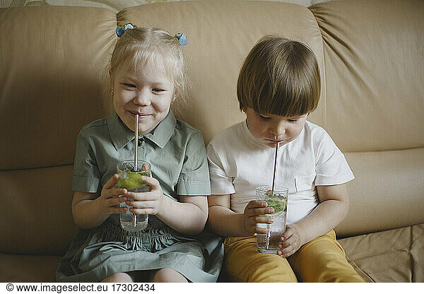 Children drink non-alcoholic mojito from reusable steel straws