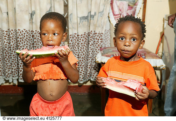 Children eating melon  Gaborone  Botswana  Africa