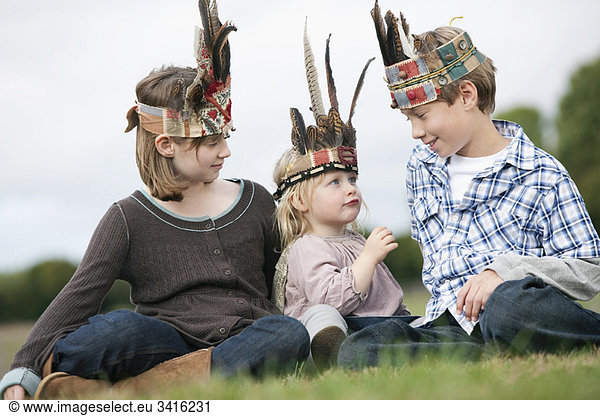 Children in Native American headgear