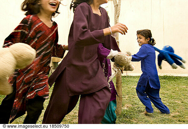 Children laugh and play in a Kabul courtyard.