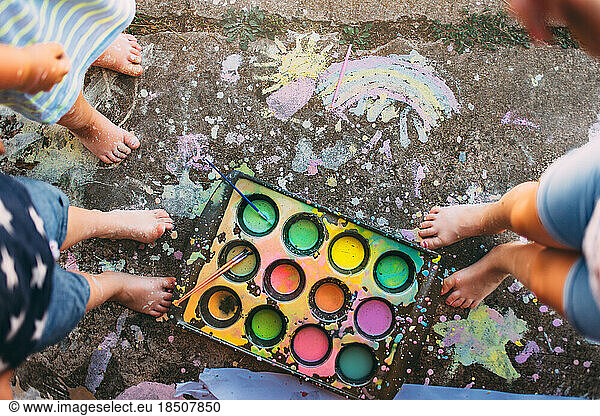 Children making art on the driveway