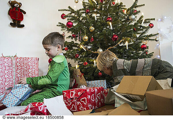Children opening Christmas gift at home