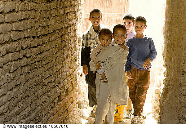 Children peek out down an alley in the morning in the neighborhood of Balakoh-he De Mazang area of Kabul.