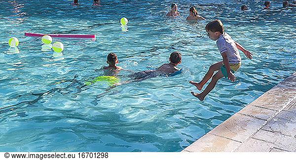 Children playing in a swimming pool.