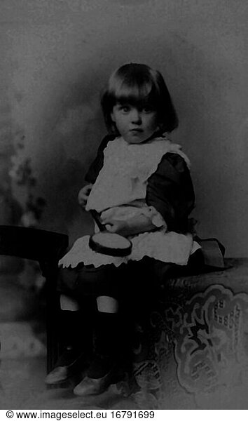 Children / Portrait / Photograph. Portrait of a little boy in a girl’s dress with a toy. Studio photo  undated  c. 1880
(Frederick Proctor  Bolton).
From a private photo album.
Archie Miles Collection 
Berlin  Sammlung Archiv für Kunst und Geschichte.