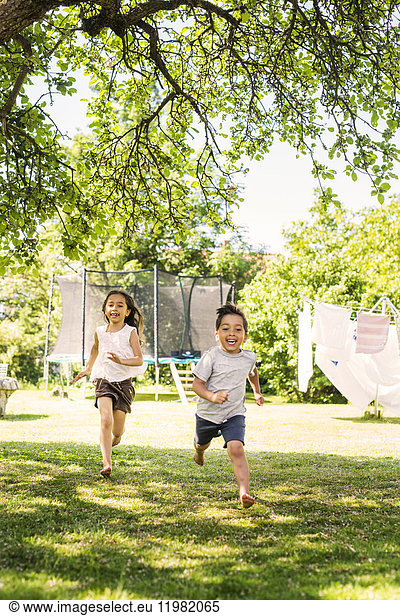Children (6-7) running on grass