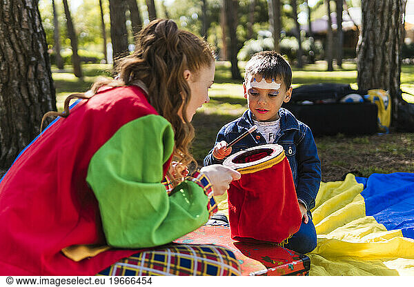 children's entertainer doing a magic trick to a child