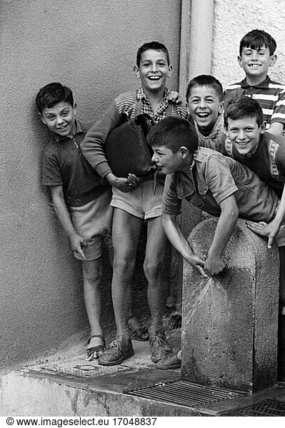 Children’s photographs: Group of boys playing with the tap of a water fountain. Photo  Biot (France)  undated.