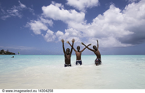 Children smile in the turquoise waters of Caribbean Sea The Nest  Antigua and Barbuda  Leeward Islands  West Indies