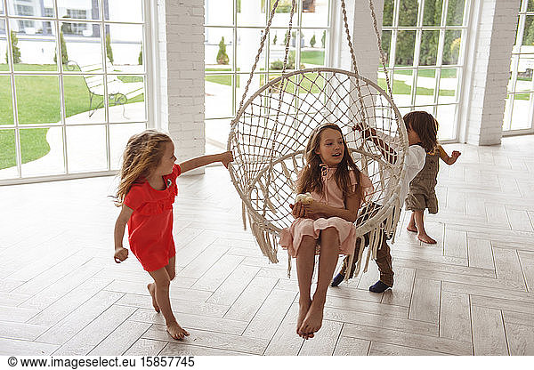children swinging on a swing