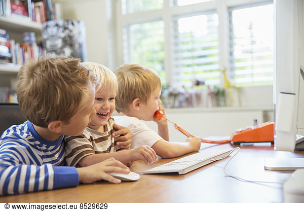 Children using home office together