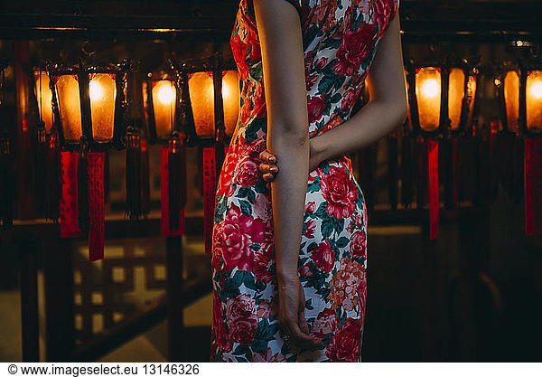 China  Hong Kong  Ma Mo Temple  back view of woman wearing dress with rose pattern  partial view
