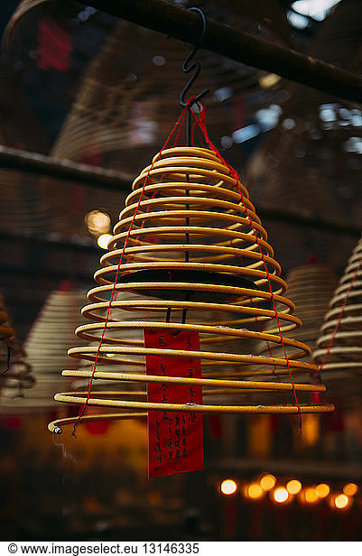 China  Hong Kong  Ma Mo Temple  burning incense spiral with prayer on red paper