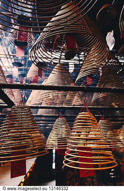 China  Hong Kong  Ma Mo Temple  burning incense spirals with prayer on red paper  close-up