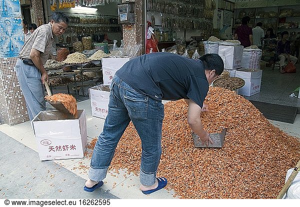 CHINA Merchants packing dry shrimps  a local delicacy  in the old quarter in Guangzhou  Guangdong province.Photo by Julio Etchart.