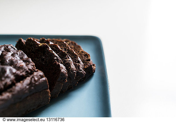 Chocolate cake slices in plate on white background
