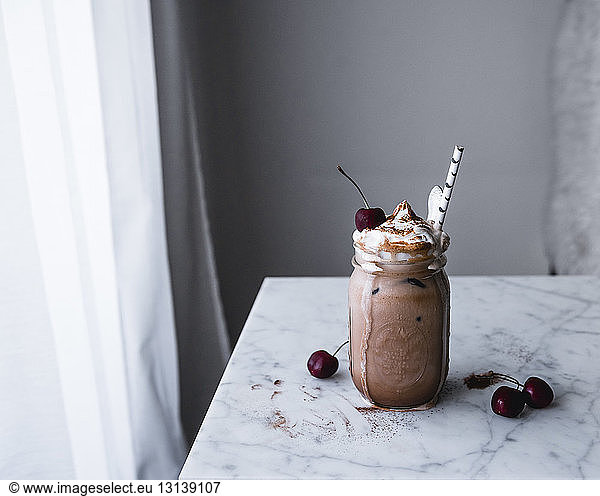 Chocolate drink in mason jar on table at home