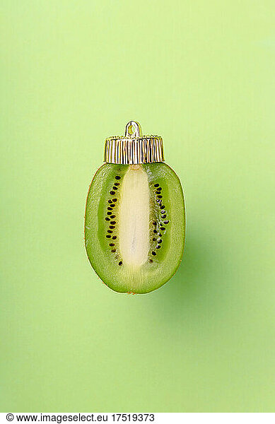 Christmas bauble decoration of kiwi on green. New year concept.