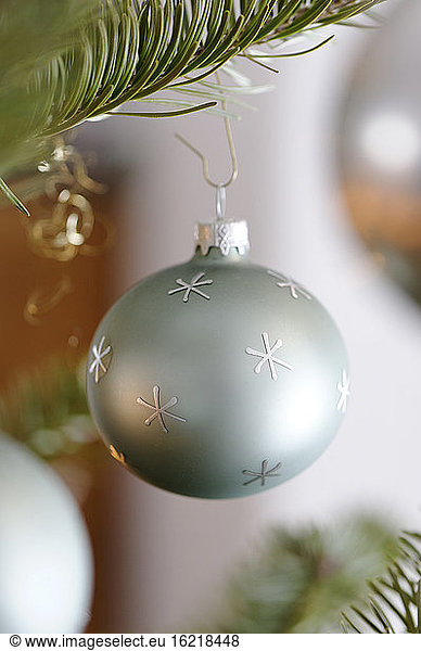 Christmas bauble hanging on tree  close up