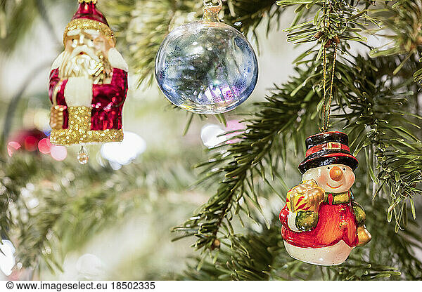 Christmas baubles and Santa Claus hanging on Christmas tree  Munich  Germany