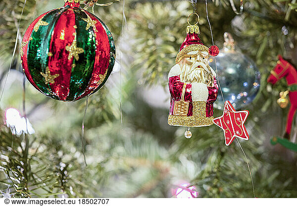Christmas baubles and snowman hanging on Christmas tree  Munich  Germany