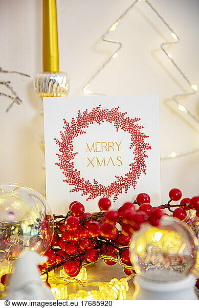 Christmas card and decoration on marble fireplace
