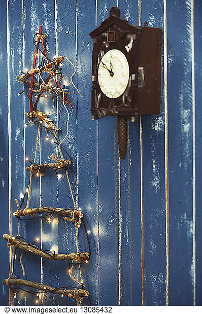 Christmas decorations hanging on blue wooden wall
