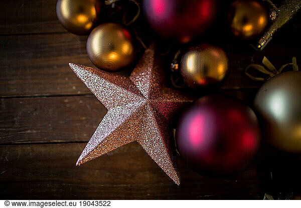 christmas ornaments on dark wood table shot from above