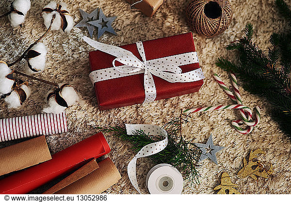 Christmas present  wrapping paper  string and bells on rug